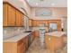Well-equipped kitchen with ample counter space, stainless appliances, and warm wood cabinetry at 8220 W Mariposa Grande Ln, Peoria, AZ 85383