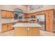 Beautiful kitchen featuring a center island, stainless steel appliances, and custom cabinetry at 8220 W Mariposa Grande Ln, Peoria, AZ 85383
