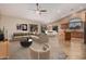 Open living space featuring high ceilings, large windows, and a ceiling fan for a bright and airy ambiance at 8220 W Mariposa Grande Ln, Peoria, AZ 85383