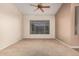 Neutral carpet and ceiling fan enhance this inviting living space at 8220 W Mariposa Grande Ln, Peoria, AZ 85383