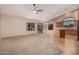 Spacious living area with neutral carpeting, ceiling fan and natural light, perfect for relaxation and entertaining at 8220 W Mariposa Grande Ln, Peoria, AZ 85383