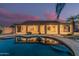 Backyard pool with palm trees and sunset in the background at 8220 W Mariposa Grande Ln, Peoria, AZ 85383