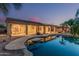 Backyard pool with covered patio, landscaping and outdoor lighting at 8220 W Mariposa Grande Ln, Peoria, AZ 85383