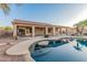 Inviting pool with in-water seating and covered patio overlooks the beautifully landscaped backyard at 8220 W Mariposa Grande Ln, Peoria, AZ 85383