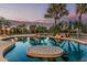 Backyard pool area with tropical landscaping and sunset at 8220 W Mariposa Grande Ln, Peoria, AZ 85383