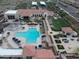 An aerial view of community clubhouse with pool, lounge areas, and manicured landscaping at 9747 S 182Nd Dr, Goodyear, AZ 85338