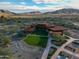 Aerial view of the property with expansive landscape, red-tiled roofs and desert mountain views at 9747 S 182Nd Dr, Goodyear, AZ 85338