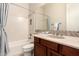 Bathroom featuring a bathtub, a shower and a single vanity sink with wood cabinets at 9747 S 182Nd Dr, Goodyear, AZ 85338