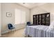 Bedroom with a blue and white bed, carpeted floor, a window with blinds and two blue velvet chairs at 9747 S 182Nd Dr, Goodyear, AZ 85338
