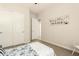 This bedroom features a bed, white sliding door closet, carpeted floor, and an accent wall painting at 9747 S 182Nd Dr, Goodyear, AZ 85338