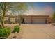 Inviting single-story home with a neutral color scheme, three-car garage, and desert landscaping at 9747 S 182Nd Dr, Goodyear, AZ 85338