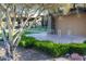 Landscaped view of the Estrella community sign, lush greenery, and modern architecture at 9747 S 182Nd Dr, Goodyear, AZ 85338