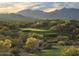 Scenic golf course surrounded by mountains and lush desert landscape at 9747 S 182Nd Dr, Goodyear, AZ 85338