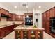 Open kitchen with island and breakfast bar features granite counters and tile backsplash at 9747 S 182Nd Dr, Goodyear, AZ 85338