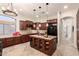 Spacious kitchen with cherry wood cabinets, granite counters, and stainless appliances at 9747 S 182Nd Dr, Goodyear, AZ 85338