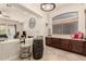Kitchen bar area with wine barrel and seating. View to living room with fireplace at 9747 S 182Nd Dr, Goodyear, AZ 85338