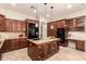 Kitchen features a granite-topped island with space for seating and modern appliances at 9747 S 182Nd Dr, Goodyear, AZ 85338