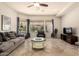 Cozy living room featuring a view of the pool, comfortable seating, and a ceiling fan at 9747 S 182Nd Dr, Goodyear, AZ 85338
