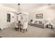 Open living area with dining space, neutral tones, and ample natural light, creating a cozy ambiance at 9747 S 182Nd Dr, Goodyear, AZ 85338