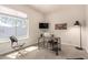 Bright office with a large window, modern desk setup, and ample natural light at 9747 S 182Nd Dr, Goodyear, AZ 85338