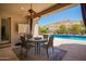 Inviting outdoor patio with comfortable seating, ceiling fan, and view of the sparkling pool at 9747 S 182Nd Dr, Goodyear, AZ 85338