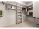 This walk-in closet features ample shelving and hanging storage, with carpeted flooring at 9747 S 182Nd Dr, Goodyear, AZ 85338