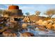 Unique stone water feature with rustic tower provides a captivating focal point in the community at 9747 S 182Nd Dr, Goodyear, AZ 85338