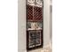 This wine cellar features decorative iron gate, wine rack, wooden shelves and a wine refrigerator at 9747 S 182Nd Dr, Goodyear, AZ 85338