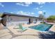 Spacious backyard with a refreshing pool, lounge seating, and ample patio space for outdoor enjoyment at 11035 N 37Th St, Phoenix, AZ 85028