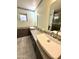 Bright bathroom featuring dual vessel sinks, granite countertops, and decorative mosaic tile accents at 11035 N 37Th St, Phoenix, AZ 85028