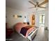 Bright bedroom with a ceiling fan and modern tile flooring, next to walk-in closet and bathroom at 11035 N 37Th St, Phoenix, AZ 85028