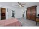 This spacious bedroom features wood-look tile floors and doorways to the bathroom and hallway at 11035 N 37Th St, Phoenix, AZ 85028