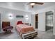 This bedroom includes a ceiling fan, tile floors, and an open walk-in closet and bathroom at 11035 N 37Th St, Phoenix, AZ 85028