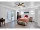 Bright bedroom features a ceiling fan, tile floors, and sliding glass doors to the outside patio at 11035 N 37Th St, Phoenix, AZ 85028