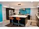 Modern kitchen featuring a large island, stainless steel appliances, and blue glass tile backsplash at 11035 N 37Th St, Phoenix, AZ 85028