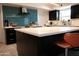 Kitchen featuring a large island, stainless steel appliances, and blue glass tile backsplash at 11035 N 37Th St, Phoenix, AZ 85028
