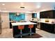 Modern kitchen featuring a large island, stainless steel appliances, and blue glass tile backsplash at 11035 N 37Th St, Phoenix, AZ 85028