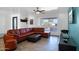 Comfortable living room with a large leather sectional couch, ottoman, and a ceiling fan at 11035 N 37Th St, Phoenix, AZ 85028