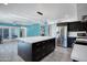 A modern living space with an open kitchen, enhanced by an inviting turquoise accent wall at 11035 N 37Th St, Phoenix, AZ 85028