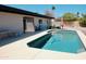 Backyard swimming pool with patio, outdoor furniture, and pink sun umbrella at 11035 N 37Th St, Phoenix, AZ 85028