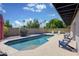 Inviting backyard pool surrounded by lush greenery and comfortable seating, perfect for relaxation at 11035 N 37Th St, Phoenix, AZ 85028