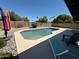 Backyard pool with lounge chairs, patio, desert landscaping, and perimeter wall at 11035 N 37Th St, Phoenix, AZ 85028