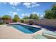 Beautiful backyard featuring a sparkling pool, lounge chairs, and an expansive patio area at 11035 N 37Th St, Phoenix, AZ 85028