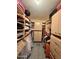 Organized walk-in closet with shelves, rods, and drawers, providing ample storage space at 11035 N 37Th St, Phoenix, AZ 85028