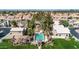 Beautiful aerial view of a community pool, surrounding houses, and green lawns in a well maintained neighborhood at 1138 E Liberty Shores Dr, Gilbert, AZ 85234