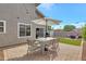 Backyard patio includes a dining table and seating with umbrellas for outdoor dining at 1138 E Liberty Shores Dr, Gilbert, AZ 85234