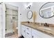 Beautiful bathroom featuring double sinks, granite countertops, and a tiled shower with glass door at 1138 E Liberty Shores Dr, Gilbert, AZ 85234
