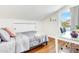 Bright bedroom with a bed, desk, and a window overlooking neighborhood at 1138 E Liberty Shores Dr, Gilbert, AZ 85234