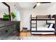 Charming bedroom featuring a bunk bed, dresser, ceiling fan and wood-look floors at 1138 E Liberty Shores Dr, Gilbert, AZ 85234