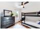 Bright bedroom features a bunk bed, dark dresser with mirror, and natural light from the window at 1138 E Liberty Shores Dr, Gilbert, AZ 85234